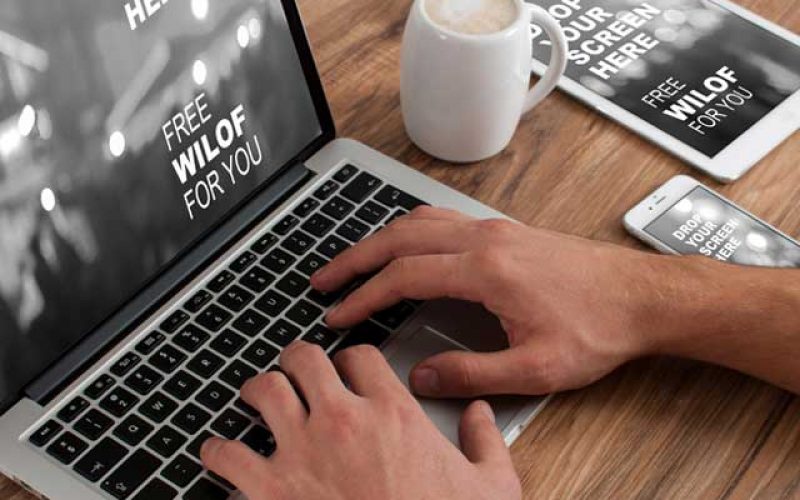 Web-Design-Mississauga person working on different devices having coffee on table